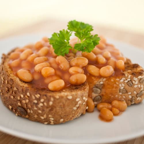 Beans on thick seeded toast with parsley garnish